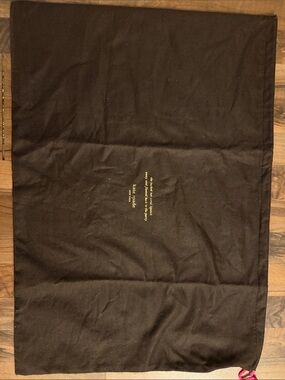 kate spade brown fabric dust cover with gold logo